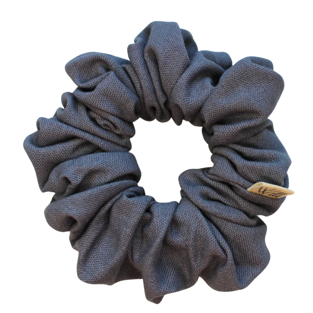 dark grey scrunchie with a brand label on a white background