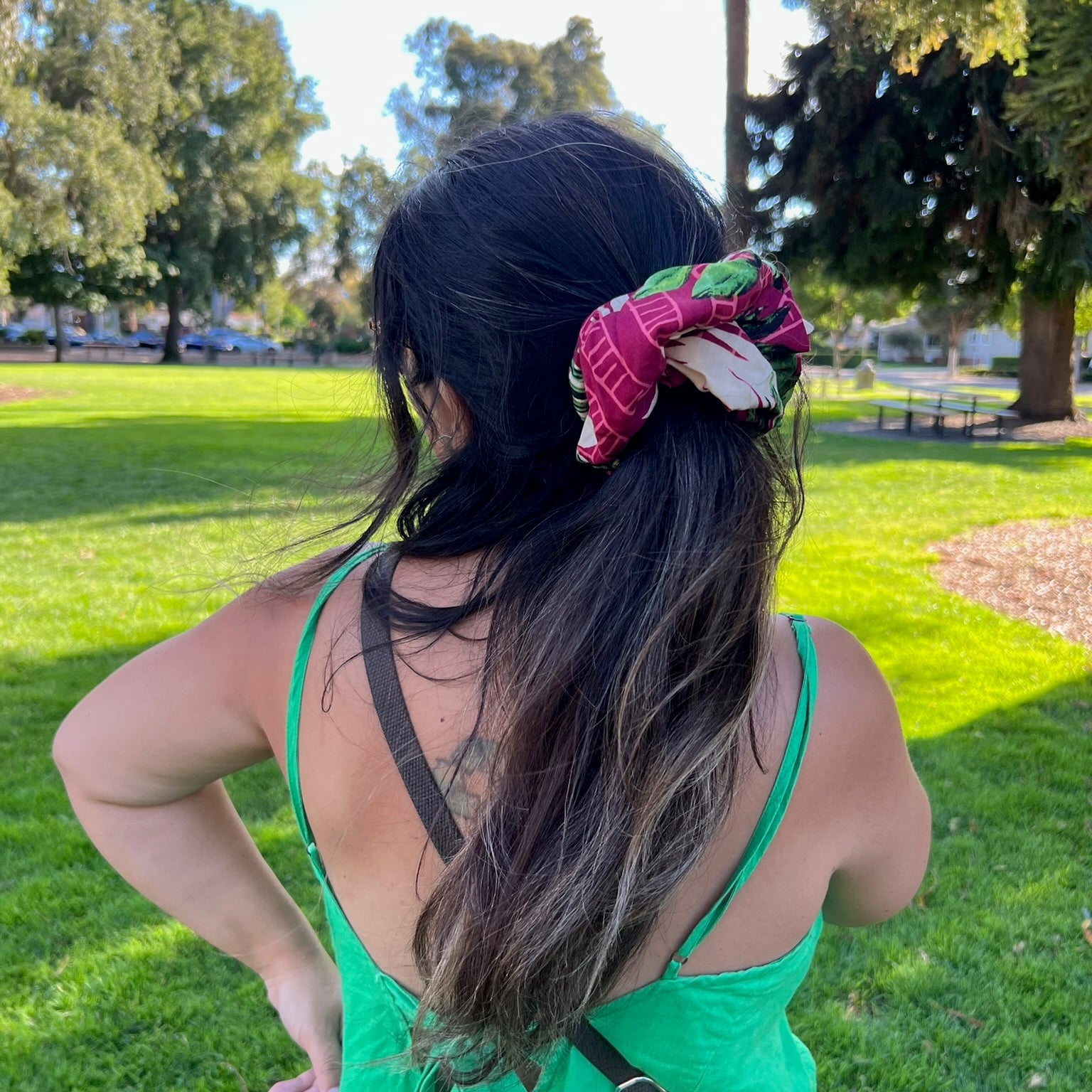 Person with a floral hair accessory in a park