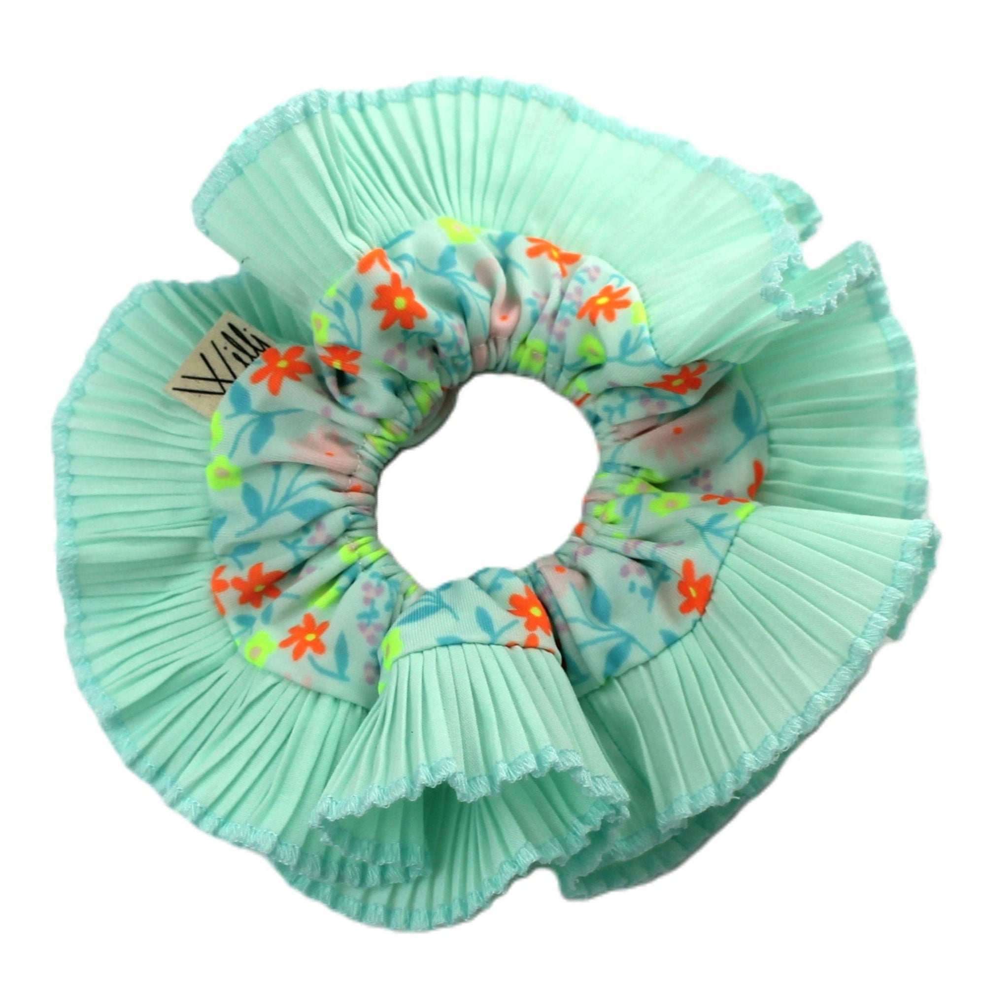 A green floral patterned double ruffle hair scrunchie.