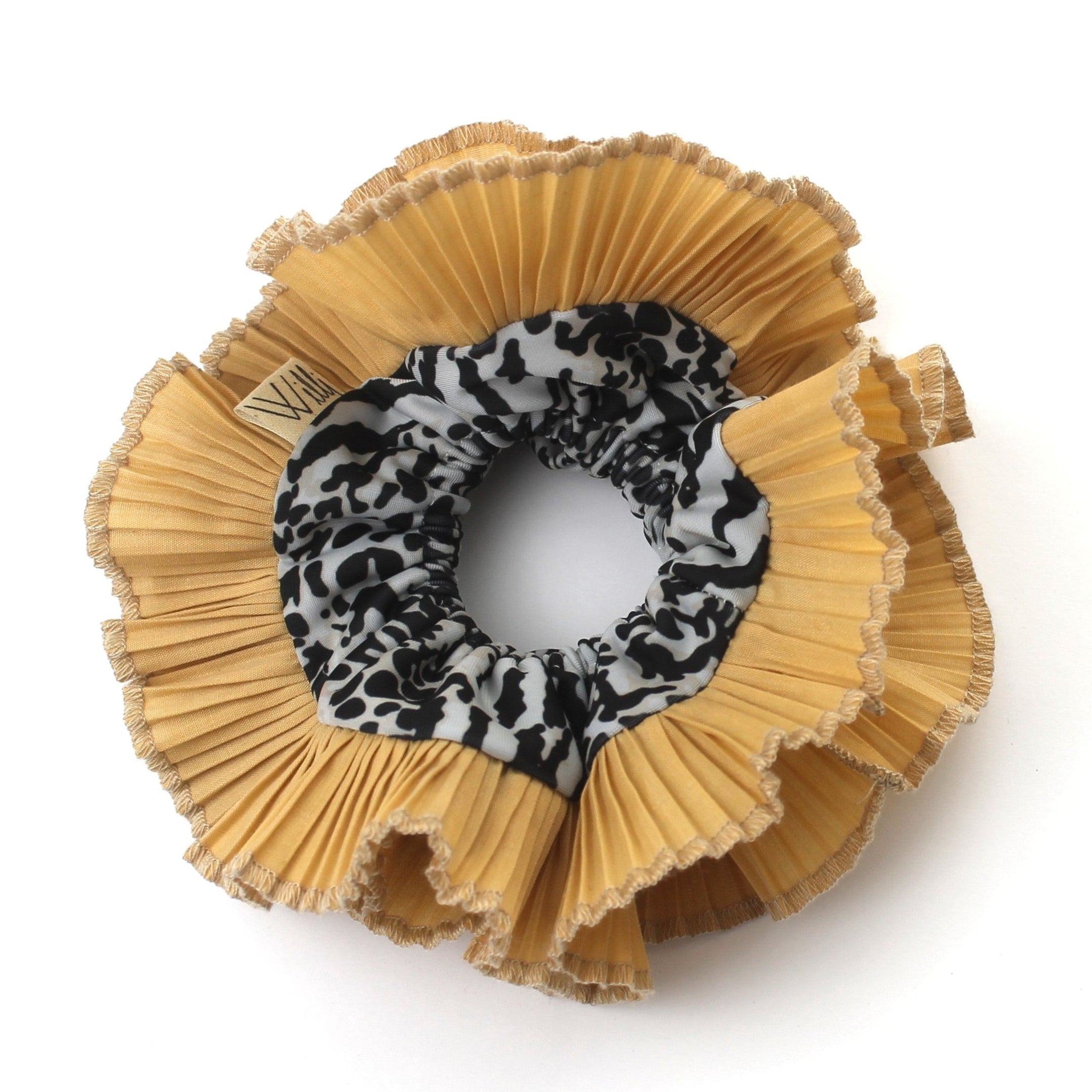 A ruffle scrunchie with a cheetah print in the center, predominantly in a beige color.