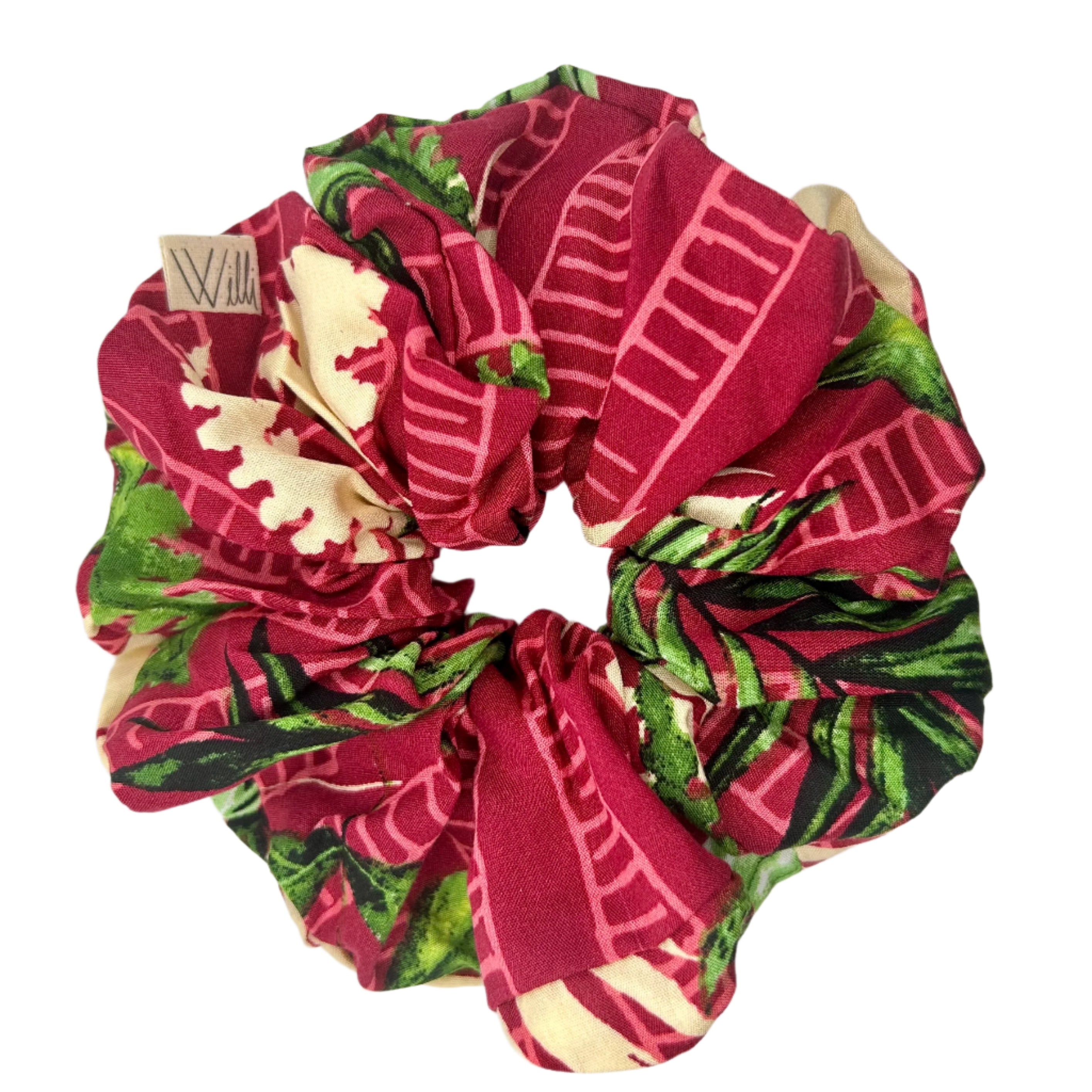scrunchie de viscosa rojo con tonos rosados y plantas verdes