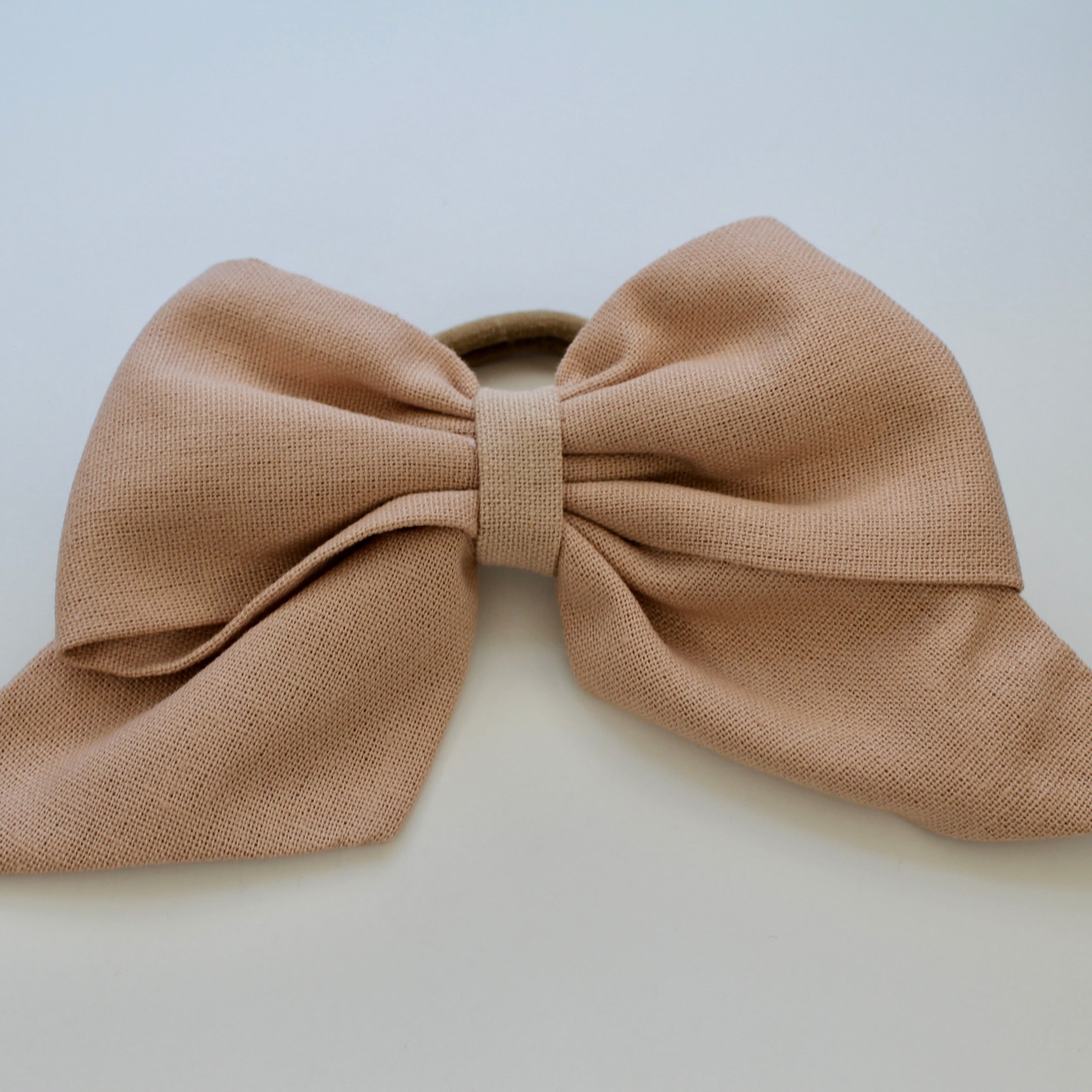 soft pink hair tie ribbon on white background
