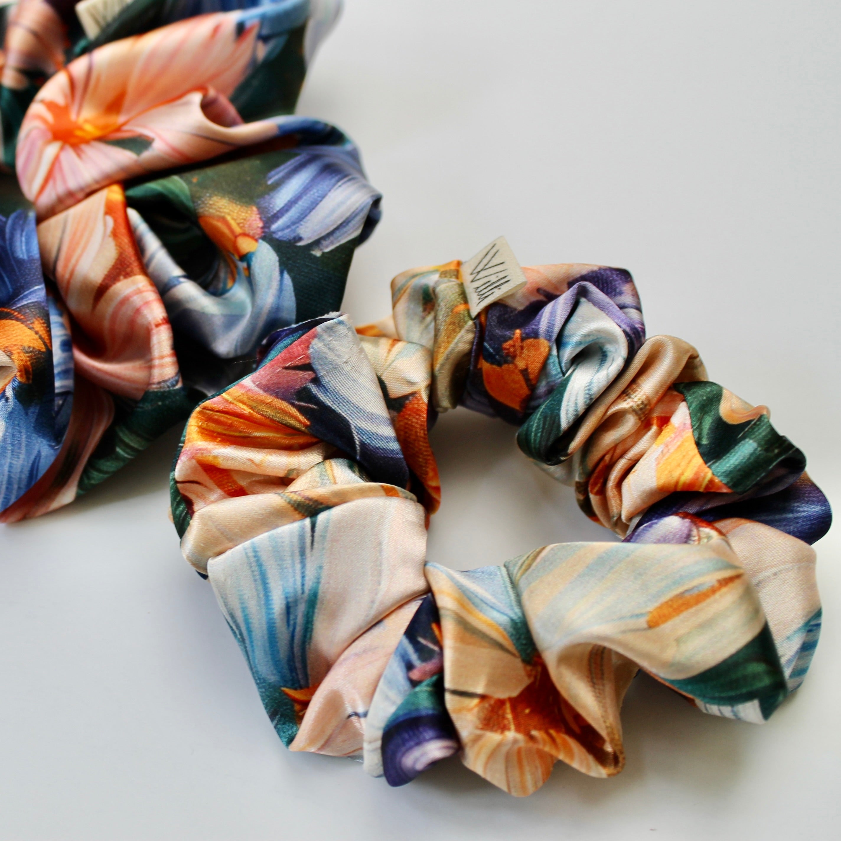 Colorful satin scrunchies on a white background