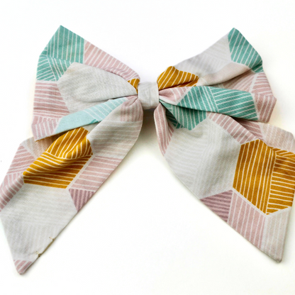 Colorful geometric patterned bow on a white background