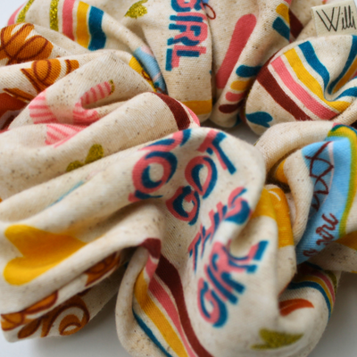 Colorful scrunchies with text and patterns on a white background