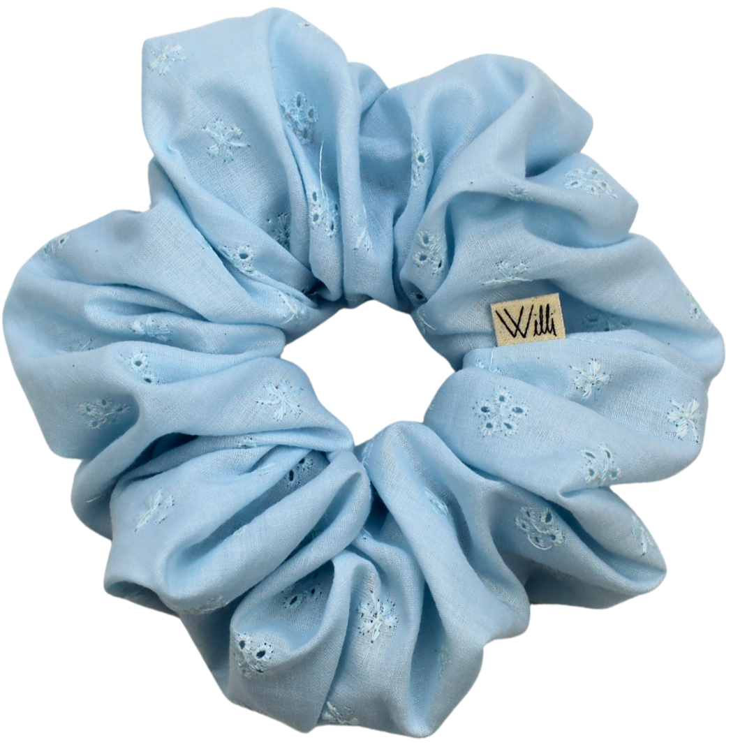 Light blue scrunchie with floral patterns on a white background