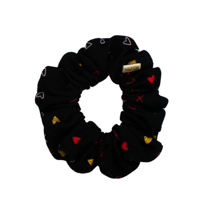 Black scrunchie with colorful heart patterns on a white background