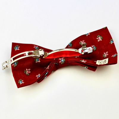 Red bow tie with floral pattern on a white background