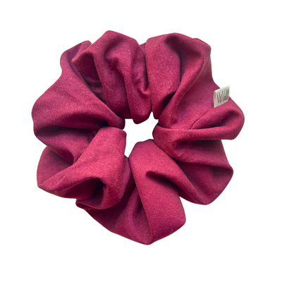 Red scrunchie with a brand label on a white background