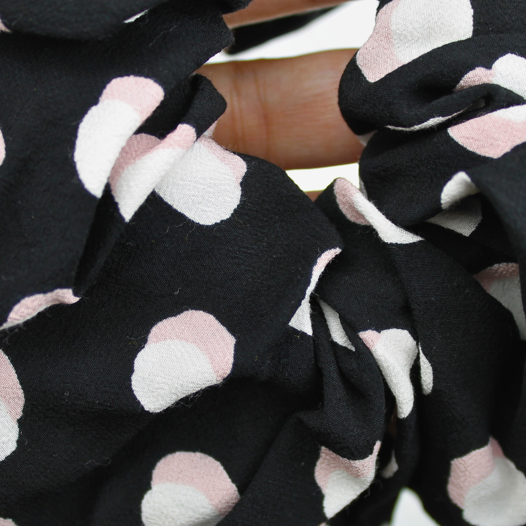 Black fabric with pink and white circules pattern