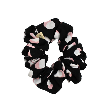 Black scrunchie with pink and white circules pattern on a white background