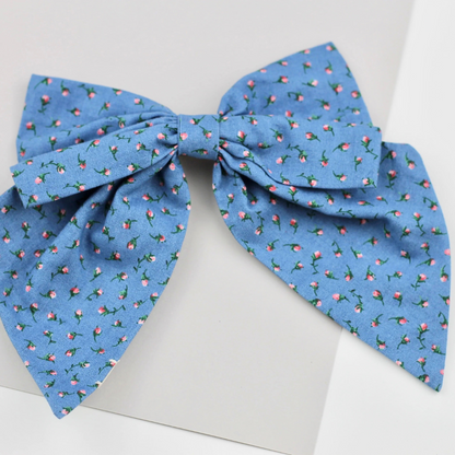 Blue floral patterned bow on a white background