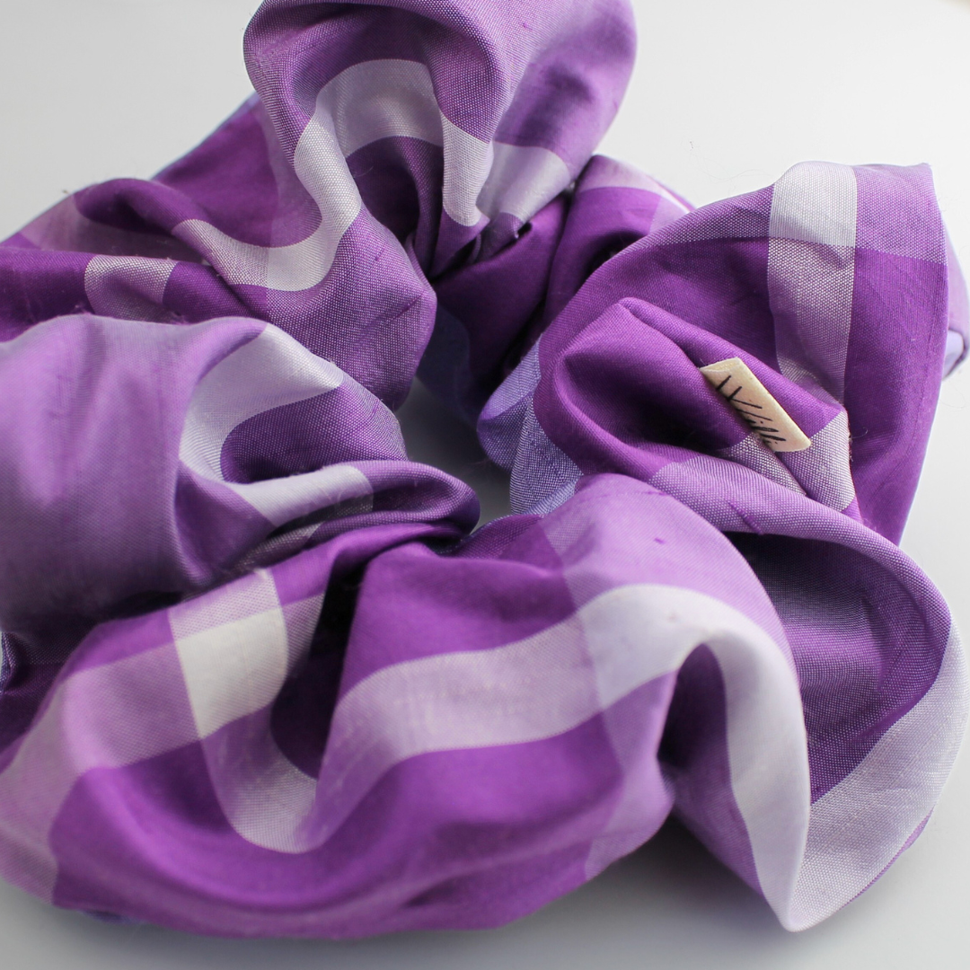 Purple and white striped scrunchie on a light background