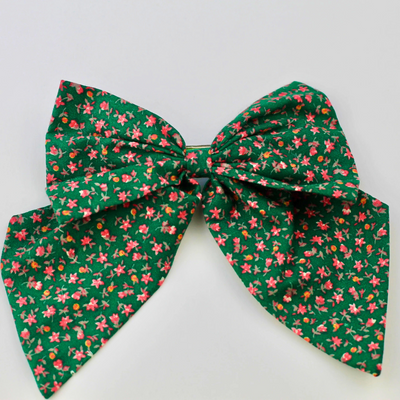 Green floral bow on a white background