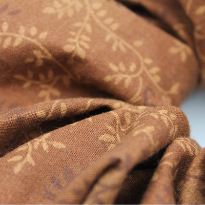 Close-up of brown fabric with subtle pattern