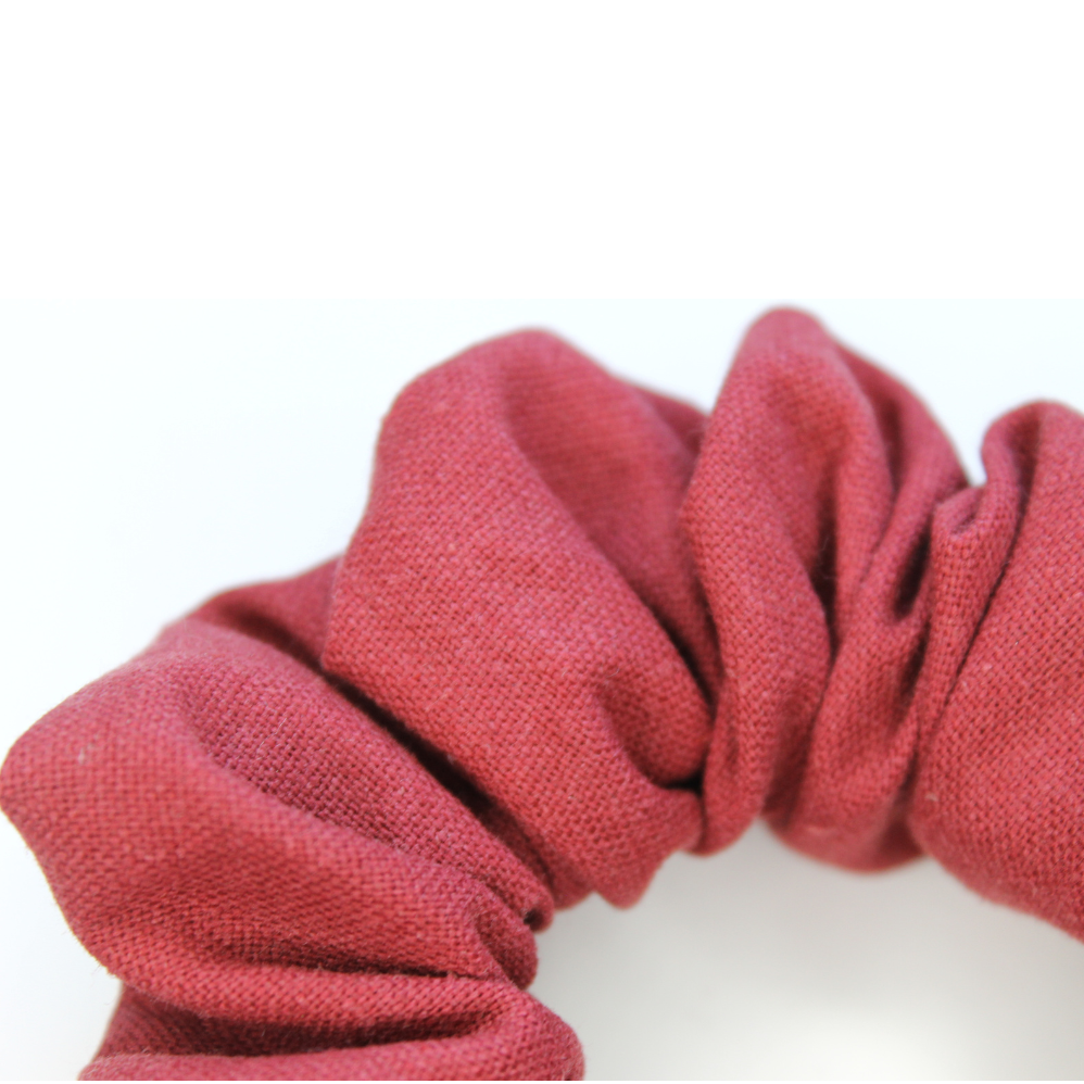 Red scrunchie on a white background