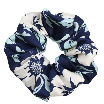 Navy and white floral patterned scrunchie on a white background