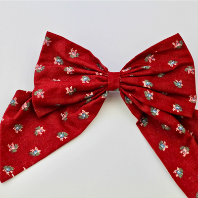 Red bow with floral patterns on a white background