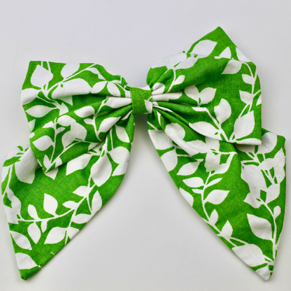 Green and white patterned bow on a light gray background