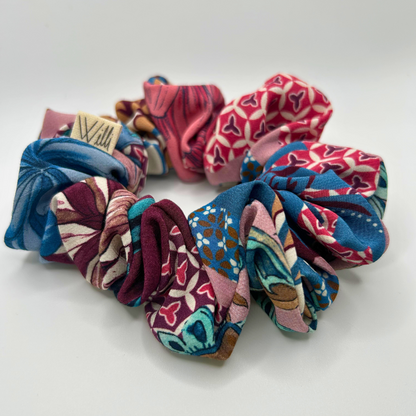 Set of colorful patterned scrunchies on a white background