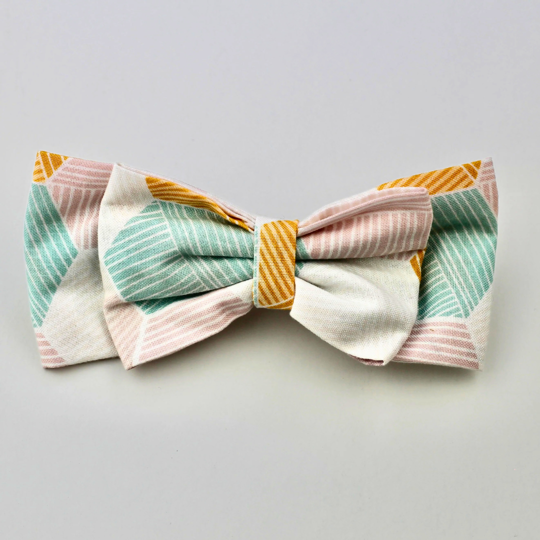 Colorful bow-shaped fabric on a light gray background