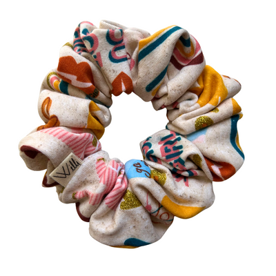 Colorful scrunchie with abstract patterns on a white background