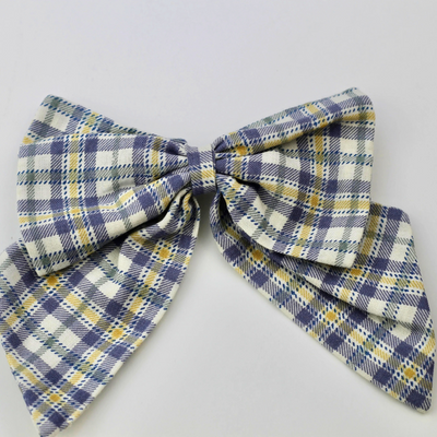 Plaid bow tie on a light gray background