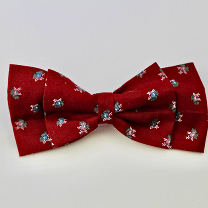 Red bow tie with floral pattern on a white background