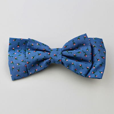 Blue bow tie with a small pattern on a light gray background