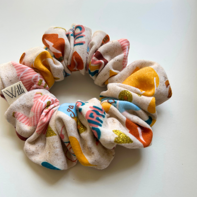 Colorful scrunchie with various patterns on a white background