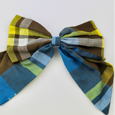 Plaid bow tie with blue, green, and brown colors on a white background