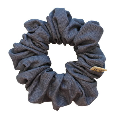 dark grey scrunchie with a brand label on a white background