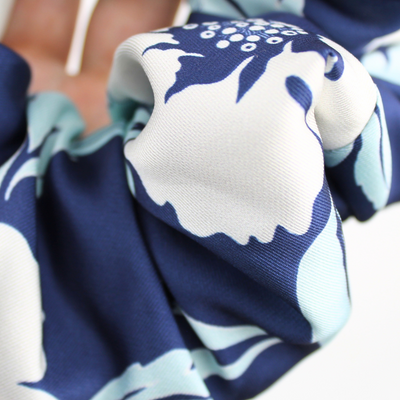 Close-up of a blue and white patterned fabric with flower designs.