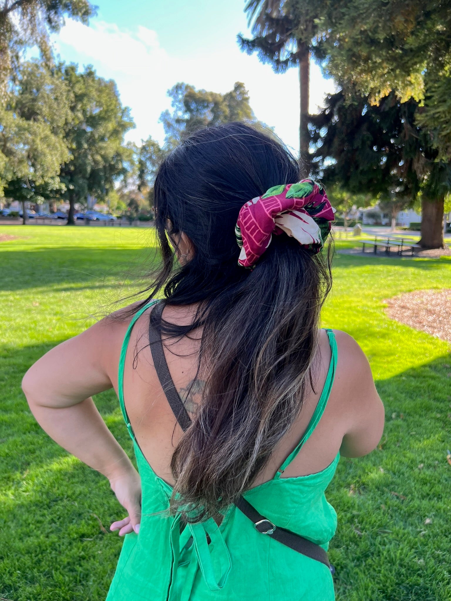 Person with a floral hair accessory in a park