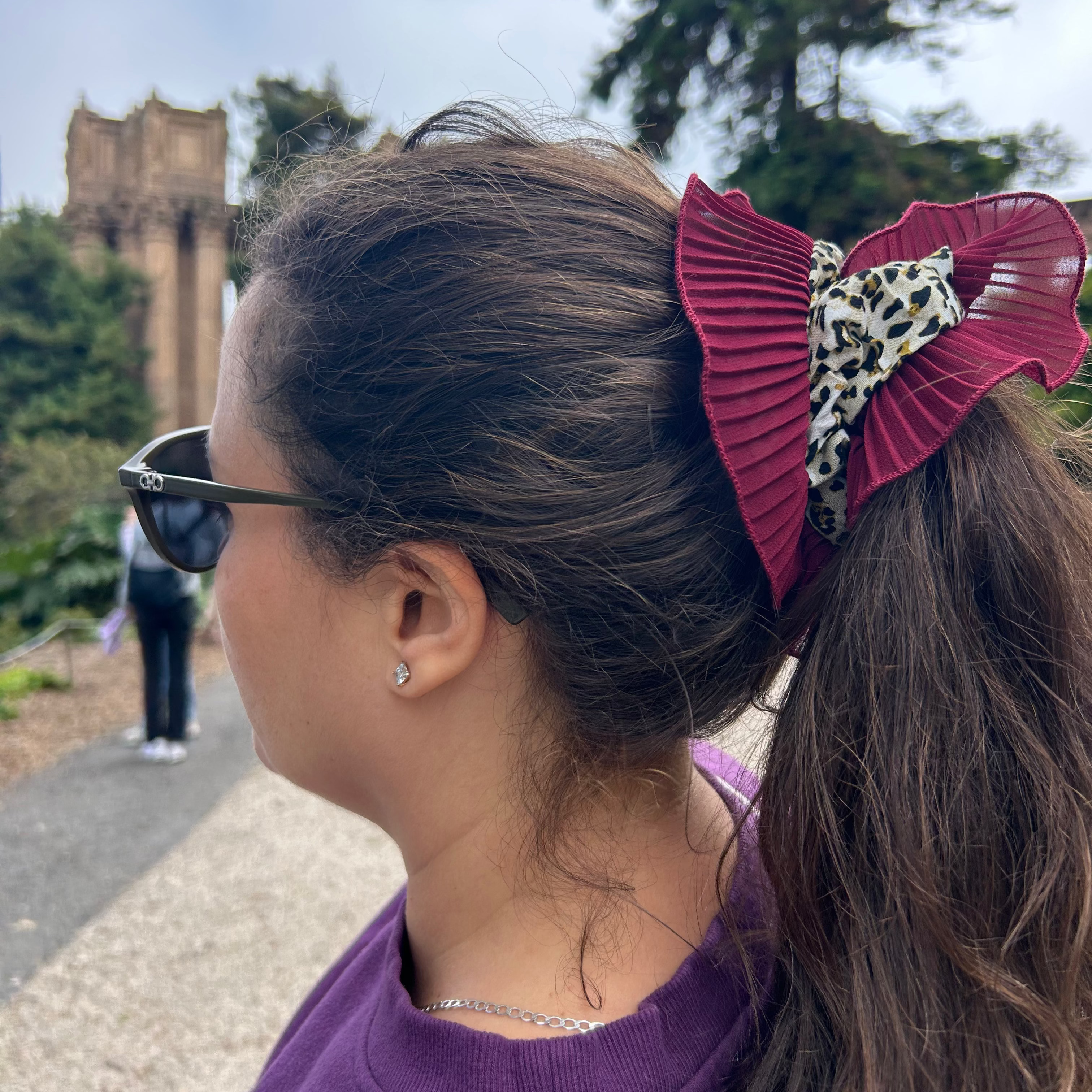 woman head with sun glases and red ruffle scrunchie with animal print fabric