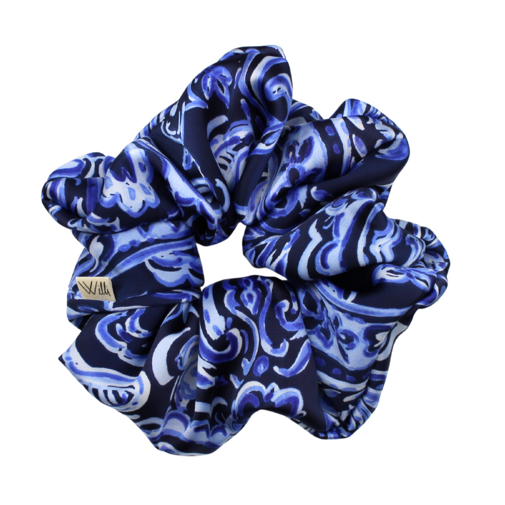 Blue and white patterned scrunchie on a white background