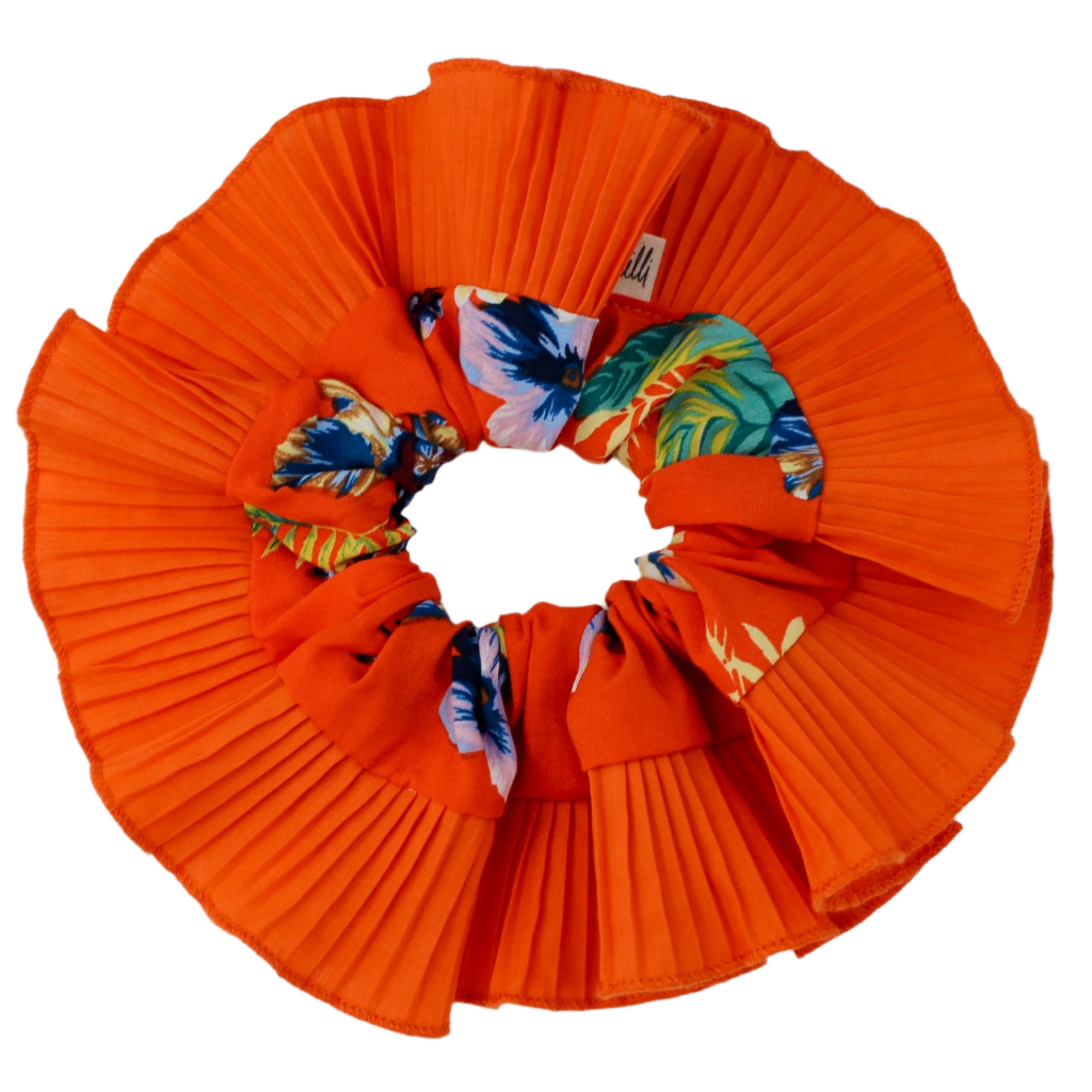 Orange pleated scrunchie with colorful floral patterns on a white background