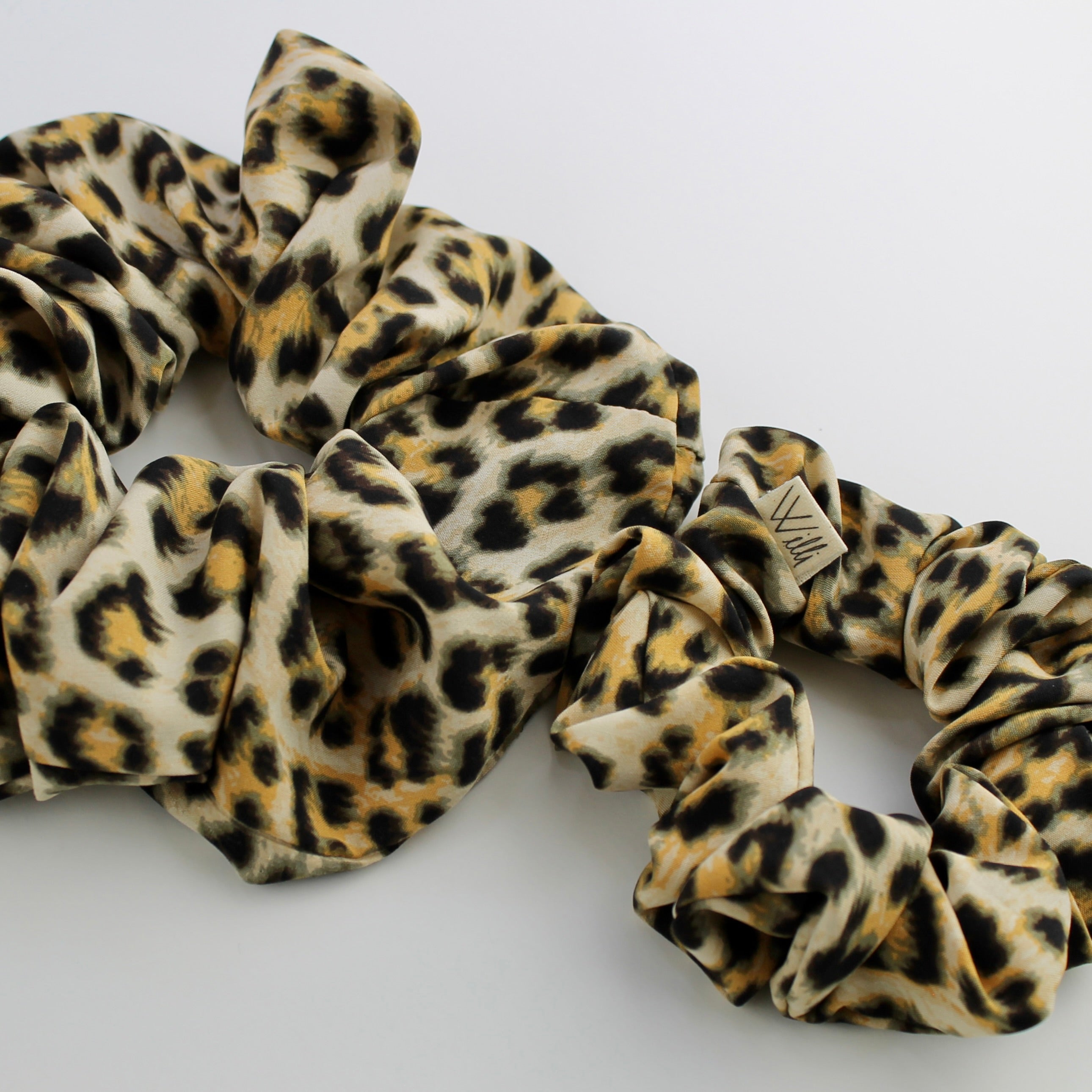 two sizes of Leopard print scrunchies on a white background