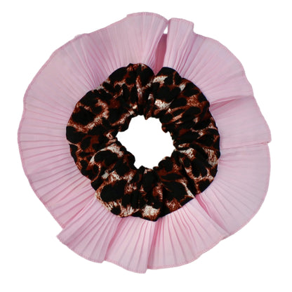 Pink scrunchie with a leopard print center on a light gray background