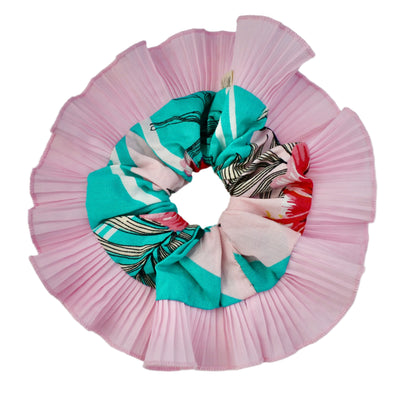 Pink pleated hair scrunchie with a colorful patterned section on a white background