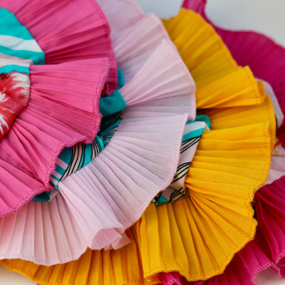 Colorful pleated fabric scrunchies on a white background
