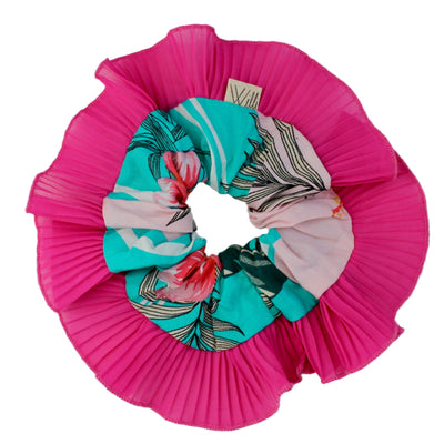 Set of colorful scrunchies on a pink pleated fabric background